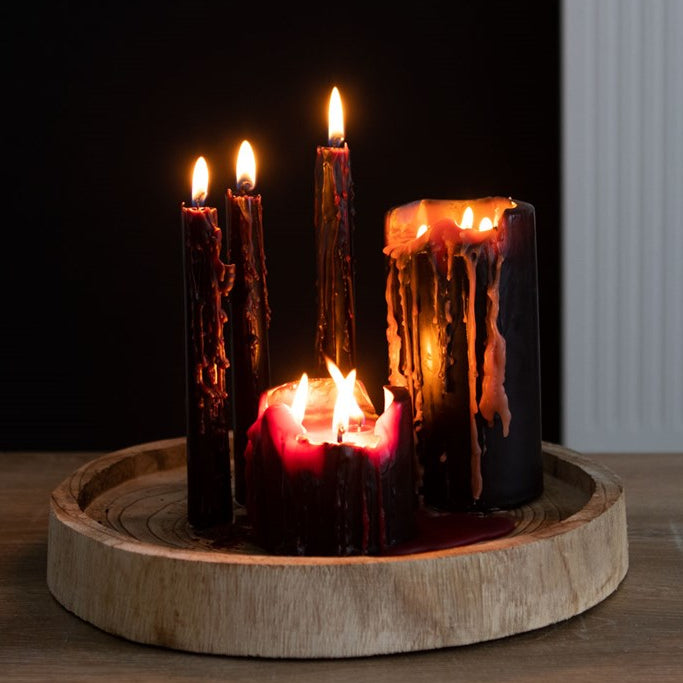 Set of candles with a wooden base on a dark background