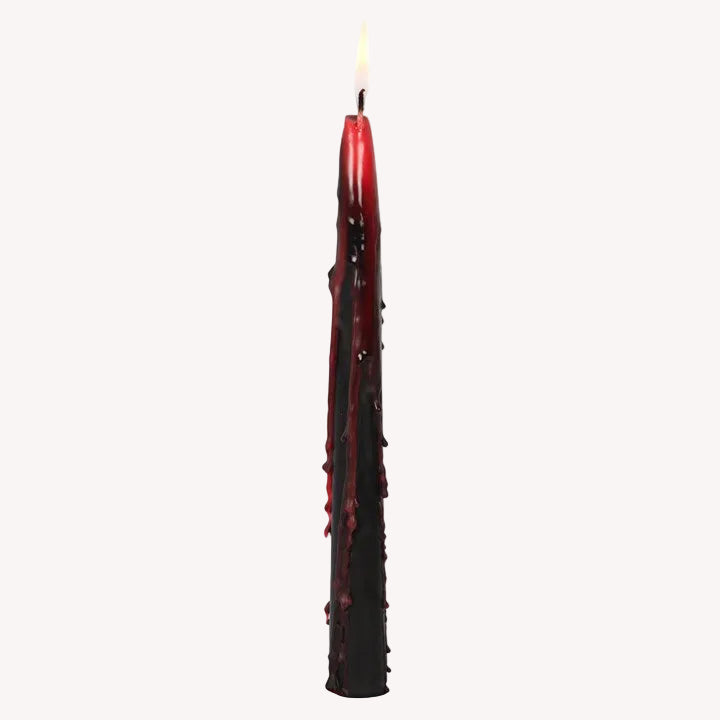 Red candle with textured surface on a white background