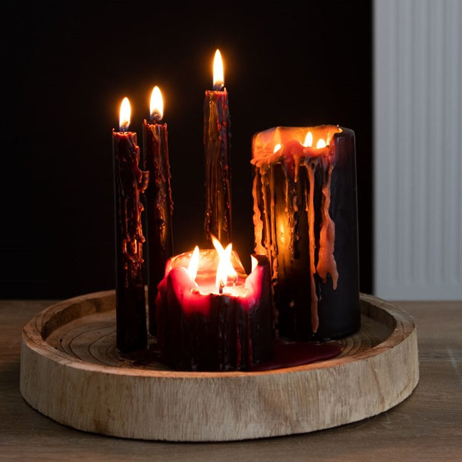 Set of candles with a wooden base on a dark background