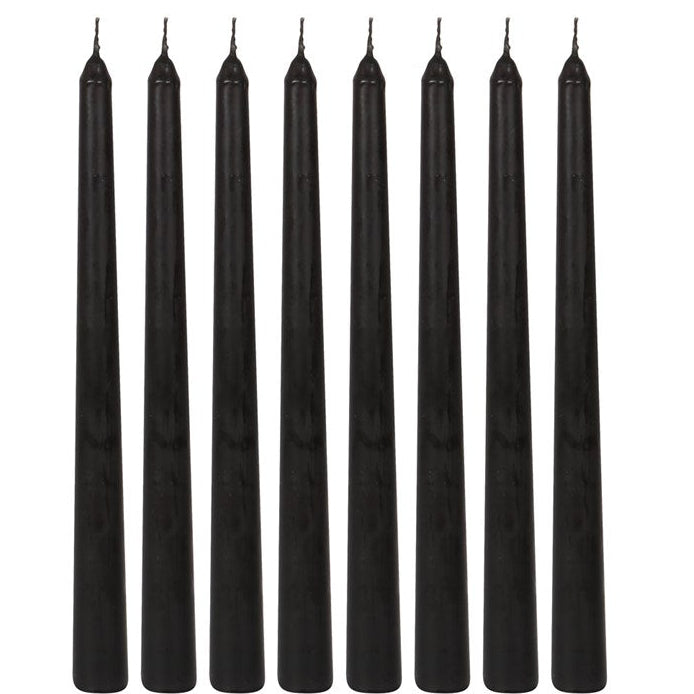 Eight black candles of uniform size and shape on a white background