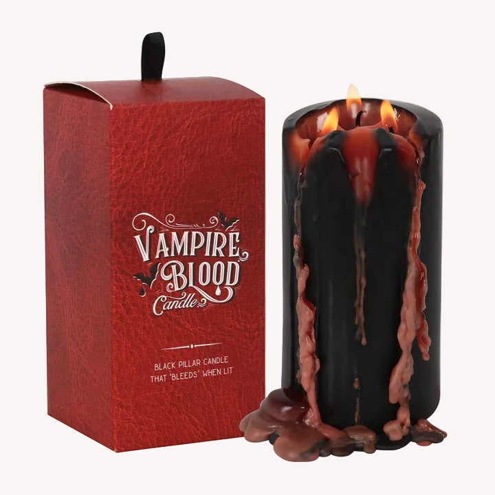 Black 'Vampire Blood' candle with red wax drips next to its red box packaging.