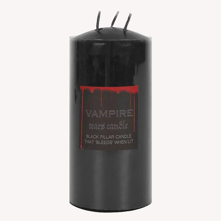 Black pillar candle with a label on a white background