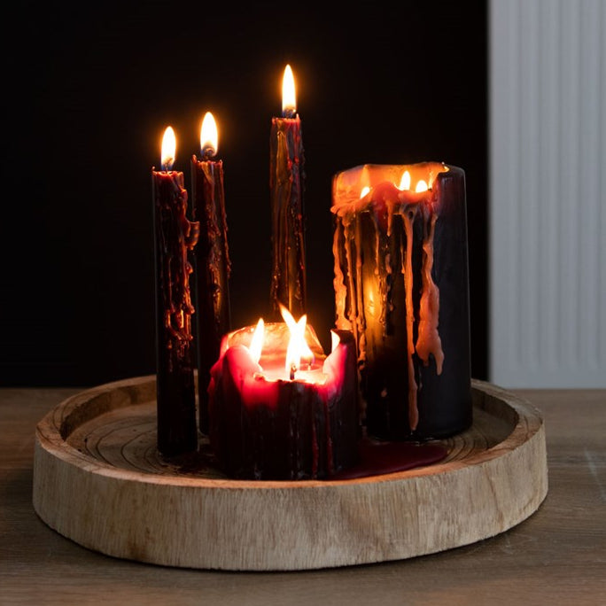 Set of candles with a wooden base on a dark background