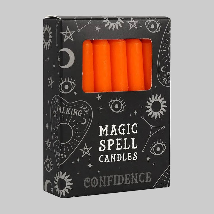 Box of orange spell candles labeled 'Confidence' with mystical designs on a white background