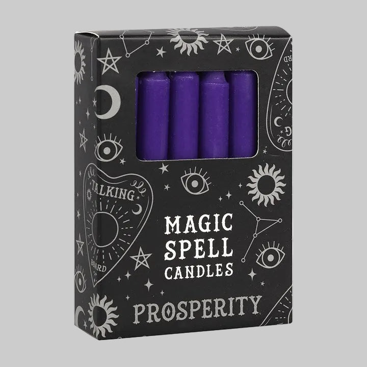 Box of purple spell candles labeled 'Magic Spell Candles Prosperity' with wiccan symbols on a white background.