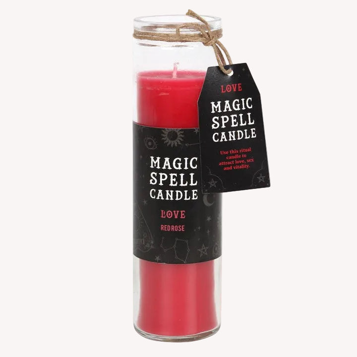 Red magic spell candle with a label on a white background