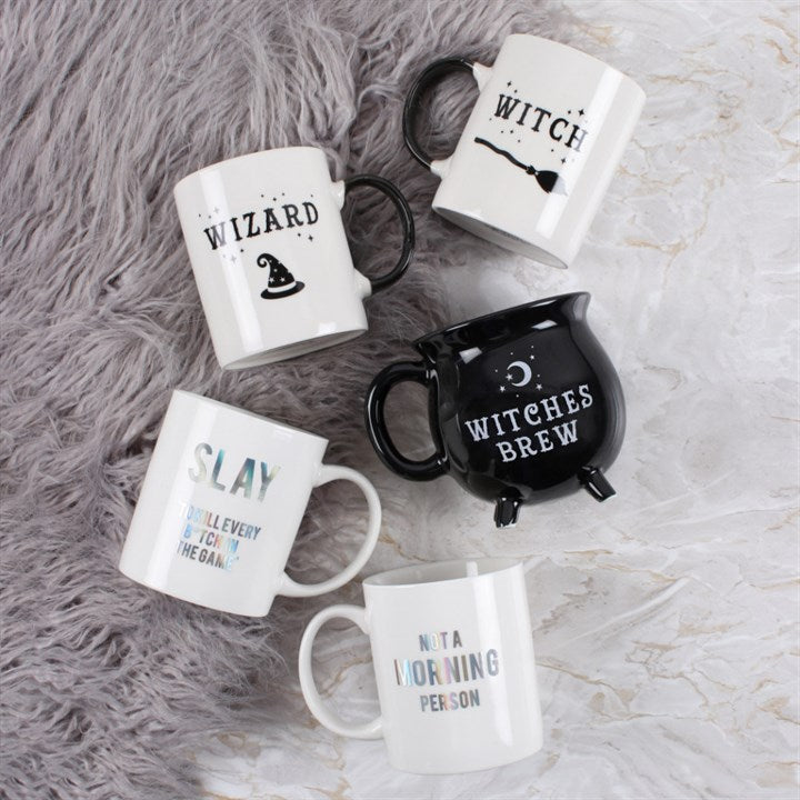 Set of Halloween-themed mugs on a textured surface