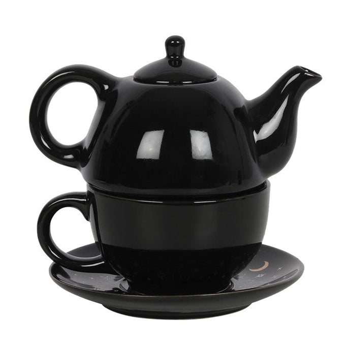 Black ceramic teapot, cup, and saucer set on a white background