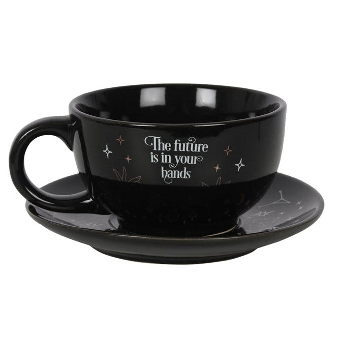 Black cup and saucer set with 'The future is in your hands' text on a white background