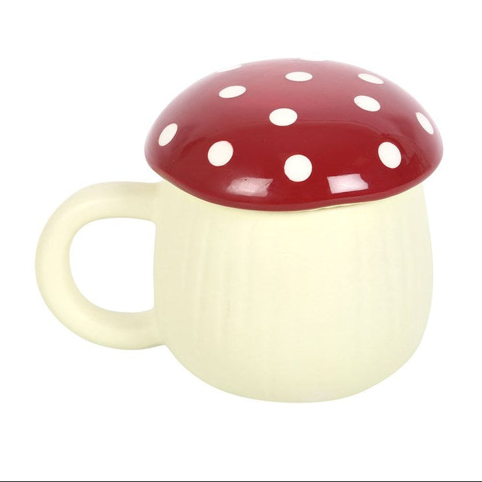 Mushroom-shaped mug with red cap and white polka dots on a white background