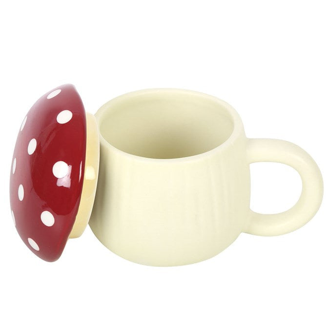 Cream-colored cup with a red mushroom-shaped lid on a white background