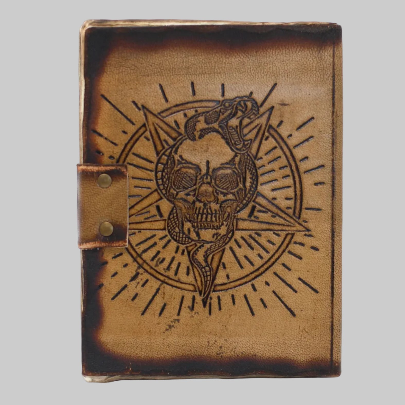 Leather-bound book with skull and pentagram design on a white background