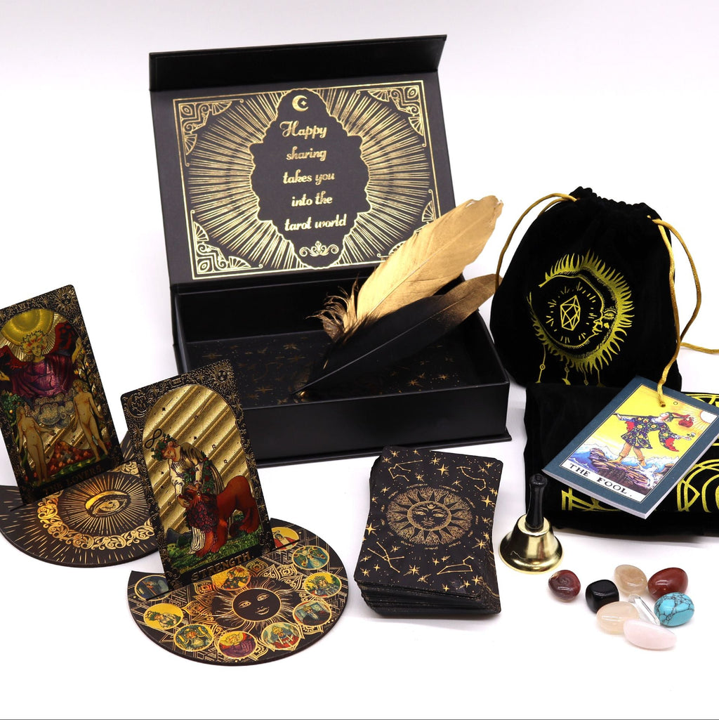 Collection of tarot cards, a deck, a box, and other accessories on a white background
