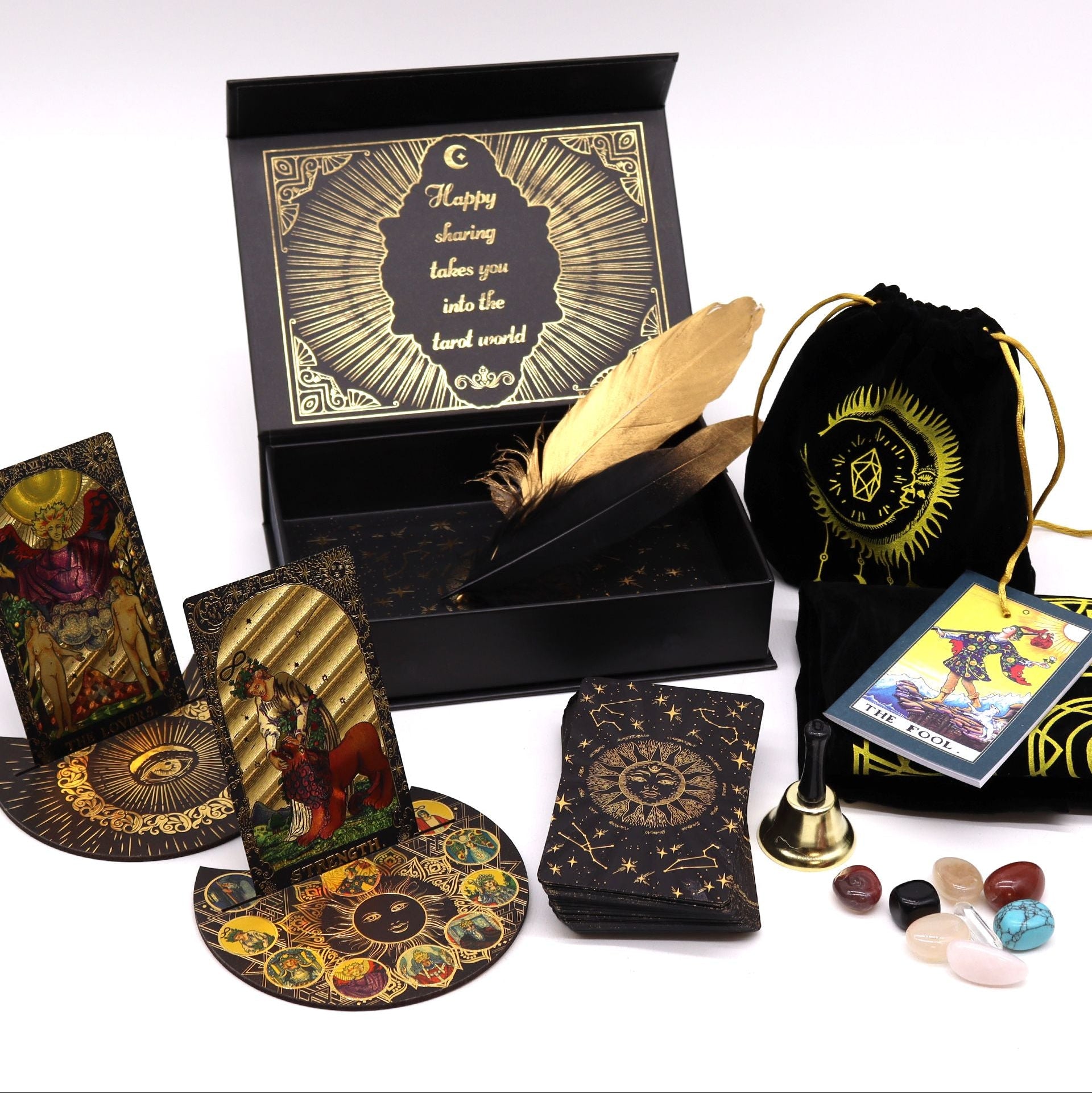 Collection of tarot cards, a deck, a box, and other accessories on a white background