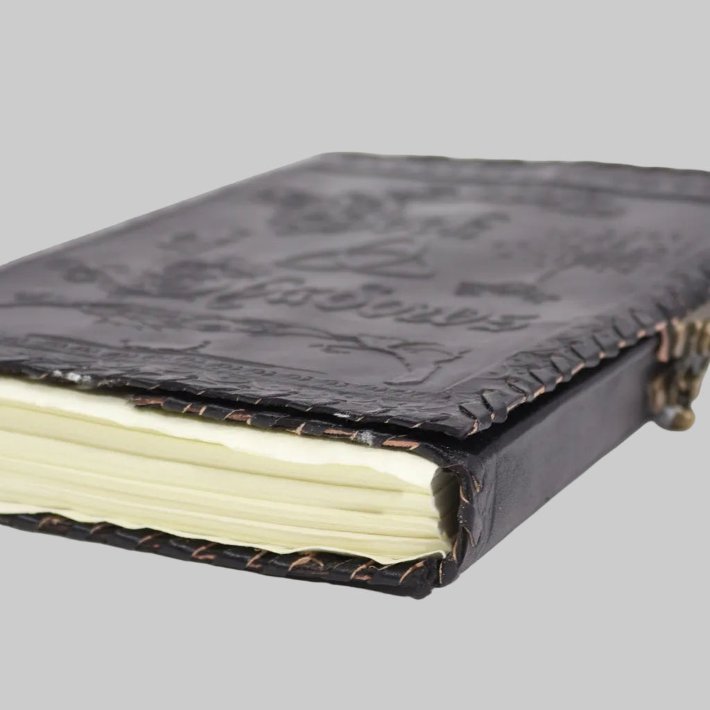 Black leather-bound notebook with embossed design on a white background
