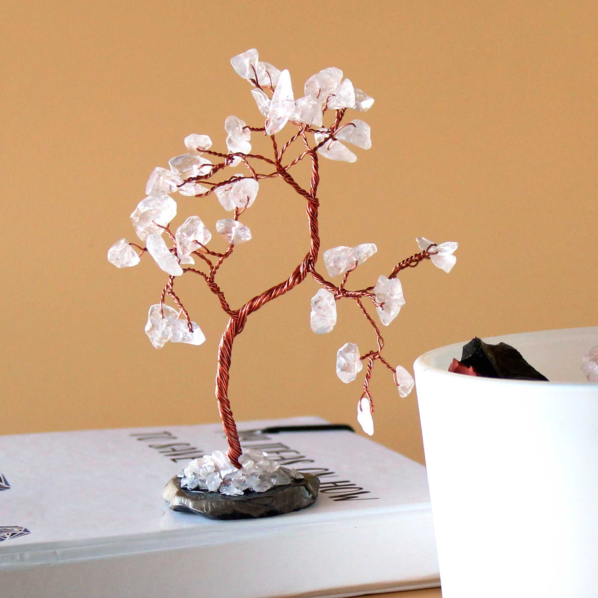 Crystal tree on a book with a beige background