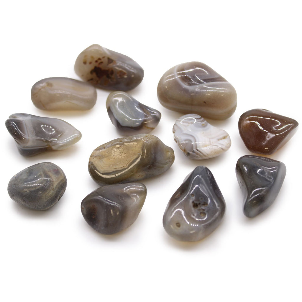 Collection of polished stones with marbled patterns on a white background
