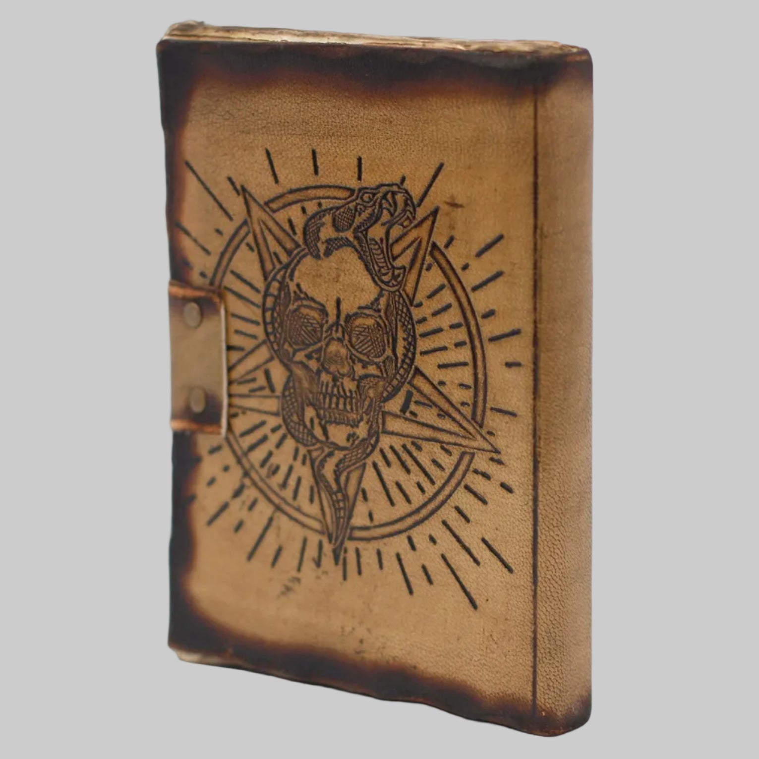 Brown leather notebook with skull and panther design on a white background