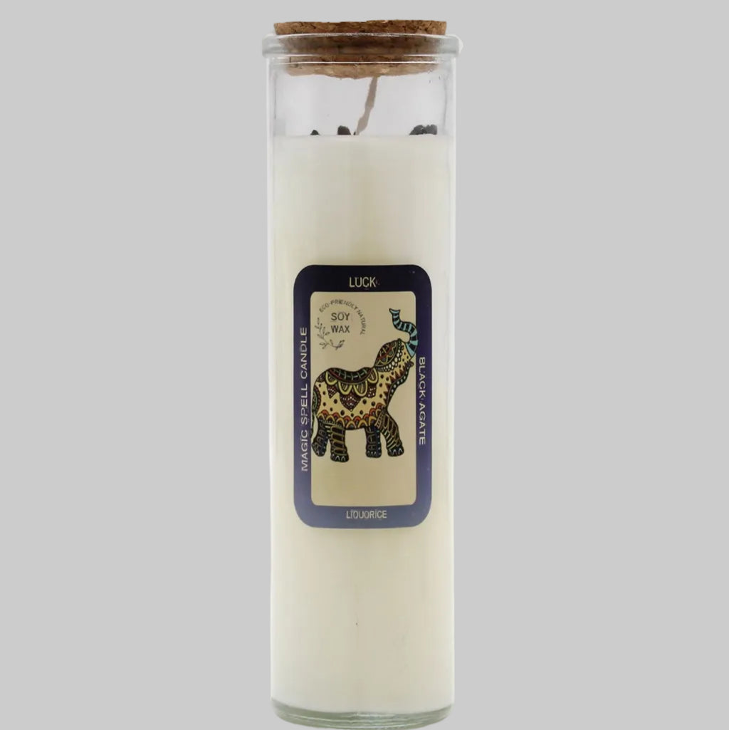 Candle in a glass jar with a decorative label featuring an elephant design on a white background