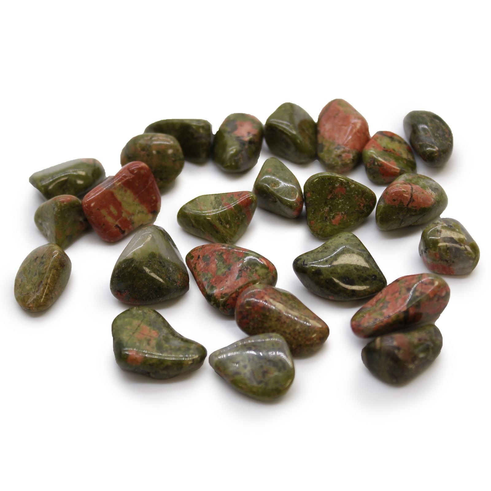 Collection of green and red stones on a white background