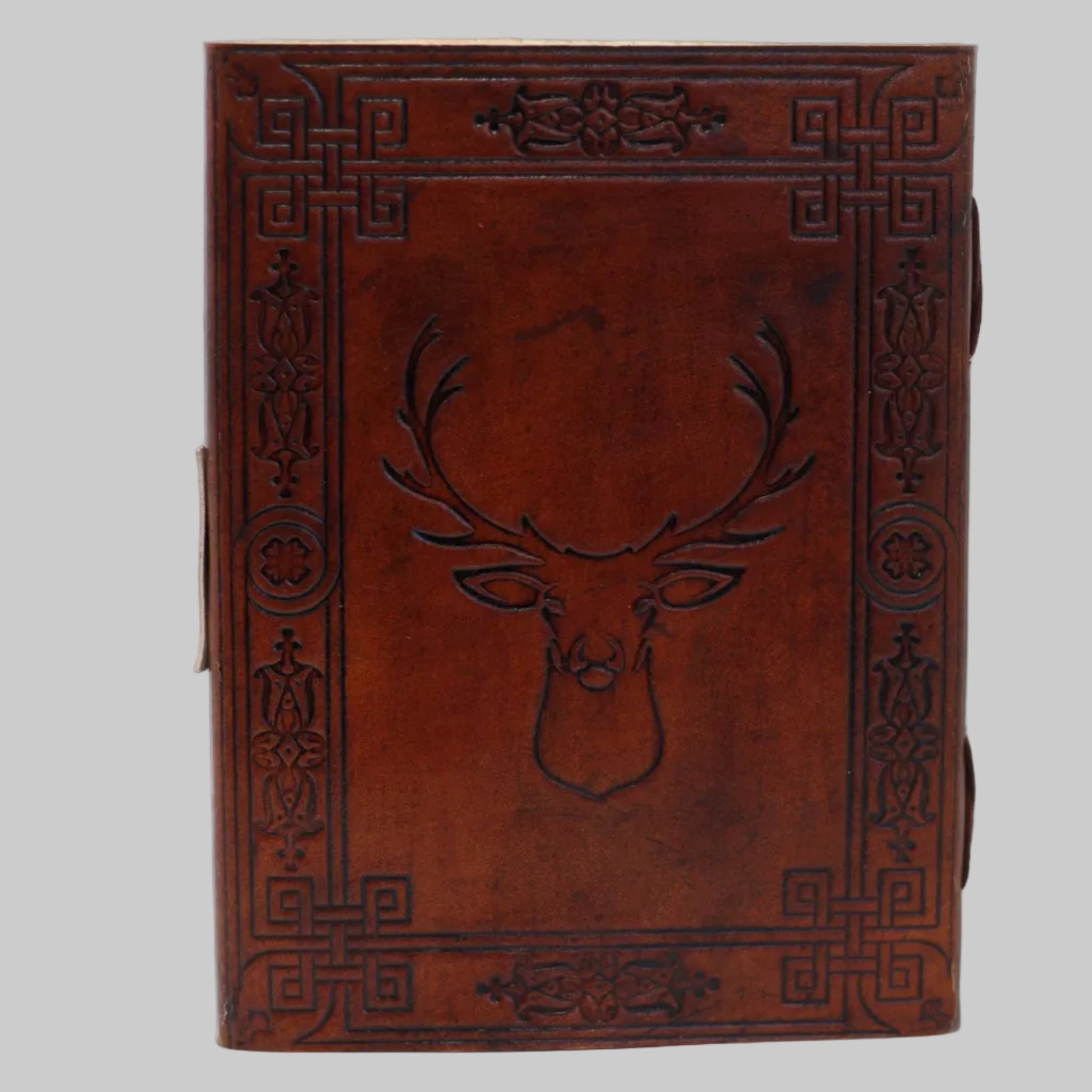 Brown leather notebook with embossed deer design on a white background