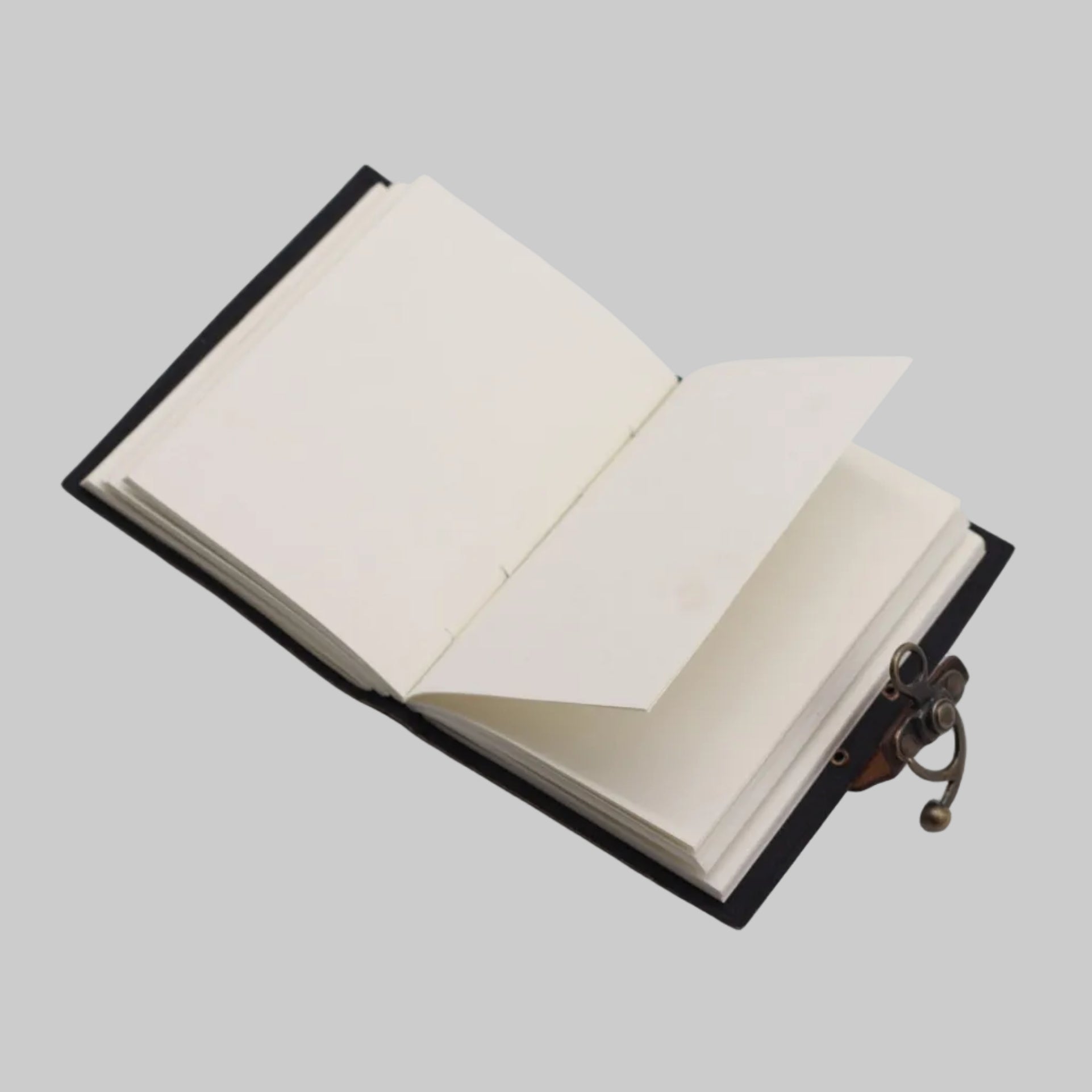 Open notebook with black leather cover and brass clasp on a white background