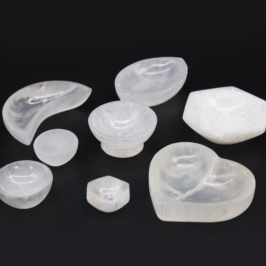 Set of various shaped white stones on a black background