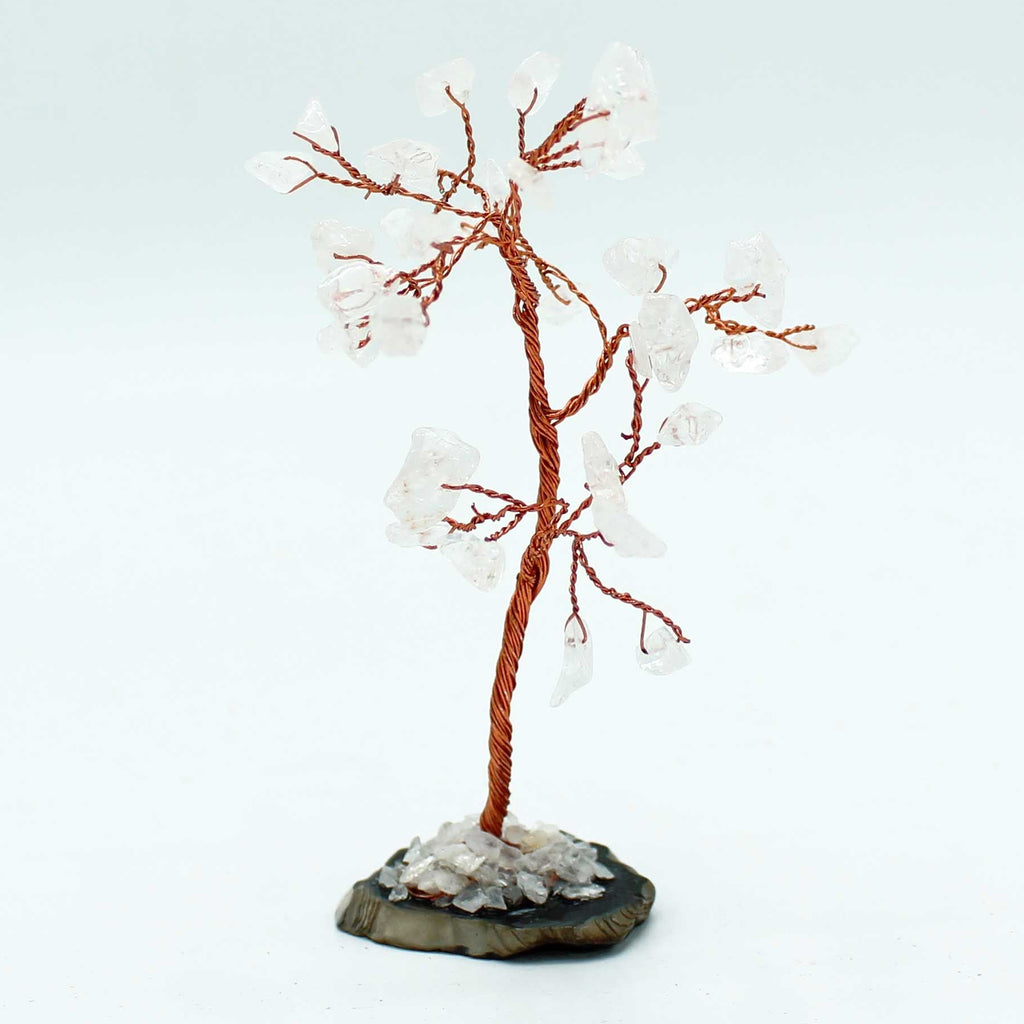 Decorative tree sculpture with white branches and a brown trunk on a light gray background