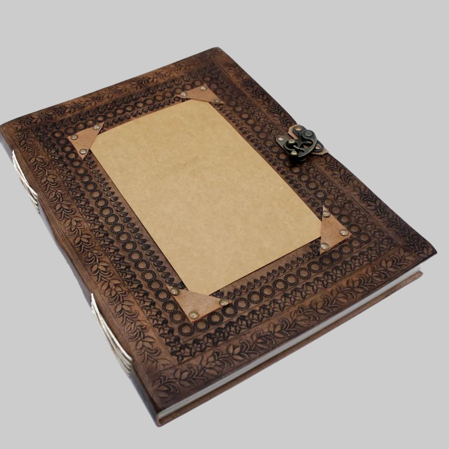 Brown leather-bound notebook with embossed design on a white background
