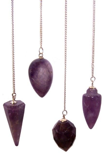 Set of amethyst pendulums on silver chains against a white background