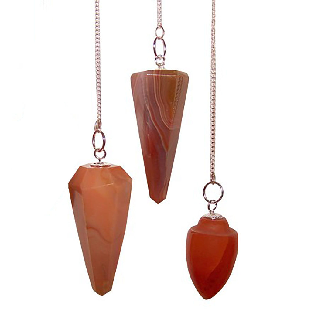 Three orange stone pendulums on silver chains against a white background