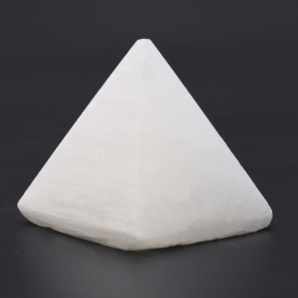 Triangular white stone on a dark background