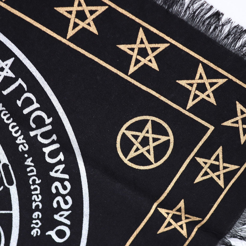 Black fabric with gold star patterns and text on a white background