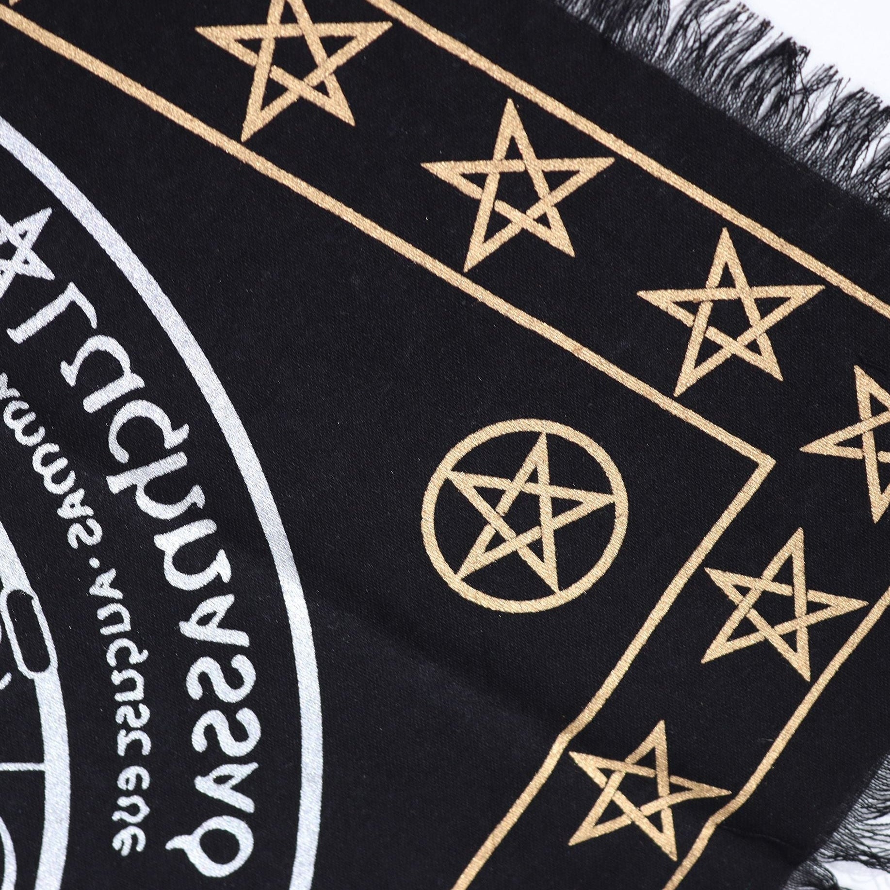 Black fabric with gold star patterns and text on a white background