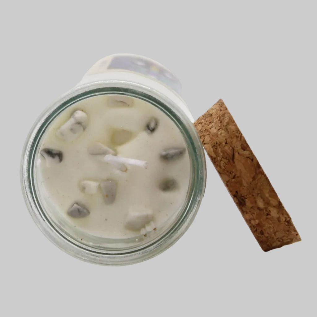 Glass jar with a candle inside, cork lid on a white background