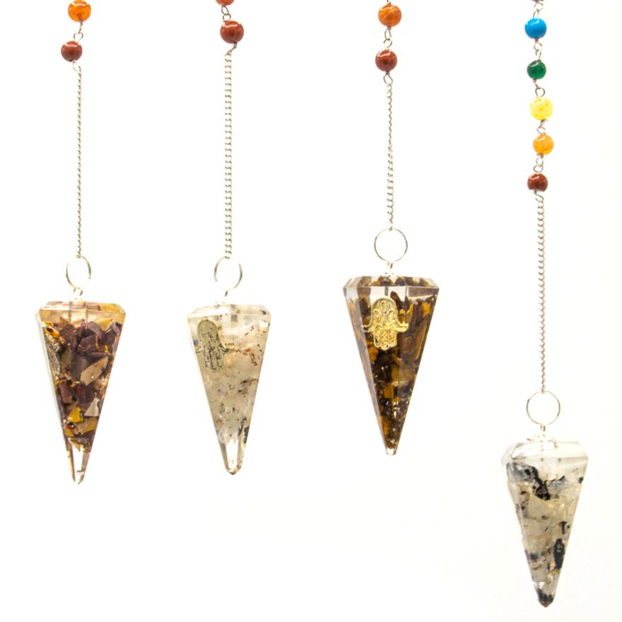 Four crystal pendulums with chains on a white background