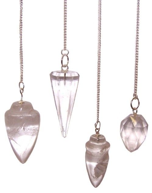 Set of four crystal pendulums on chains against a white background