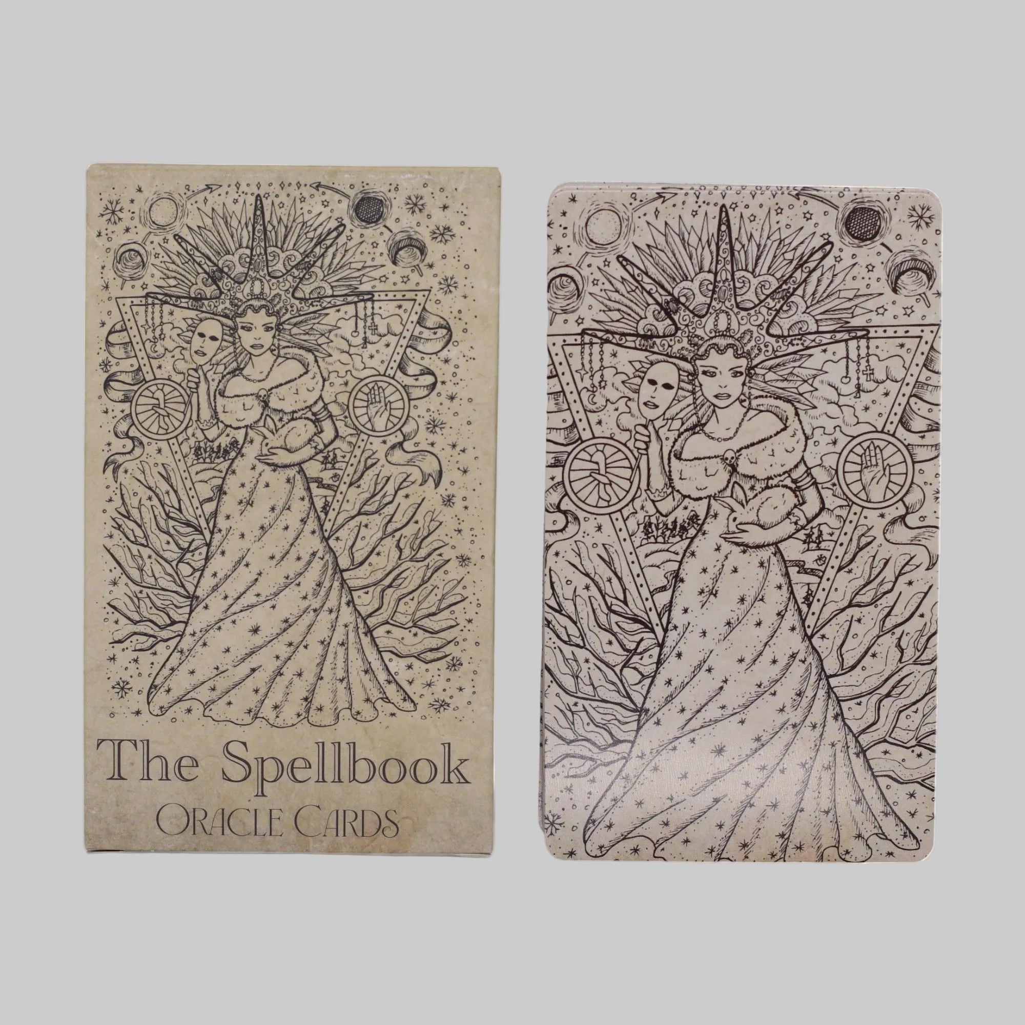 Two oracle card decks with a woman in a dress and celestial symbols on a white background.