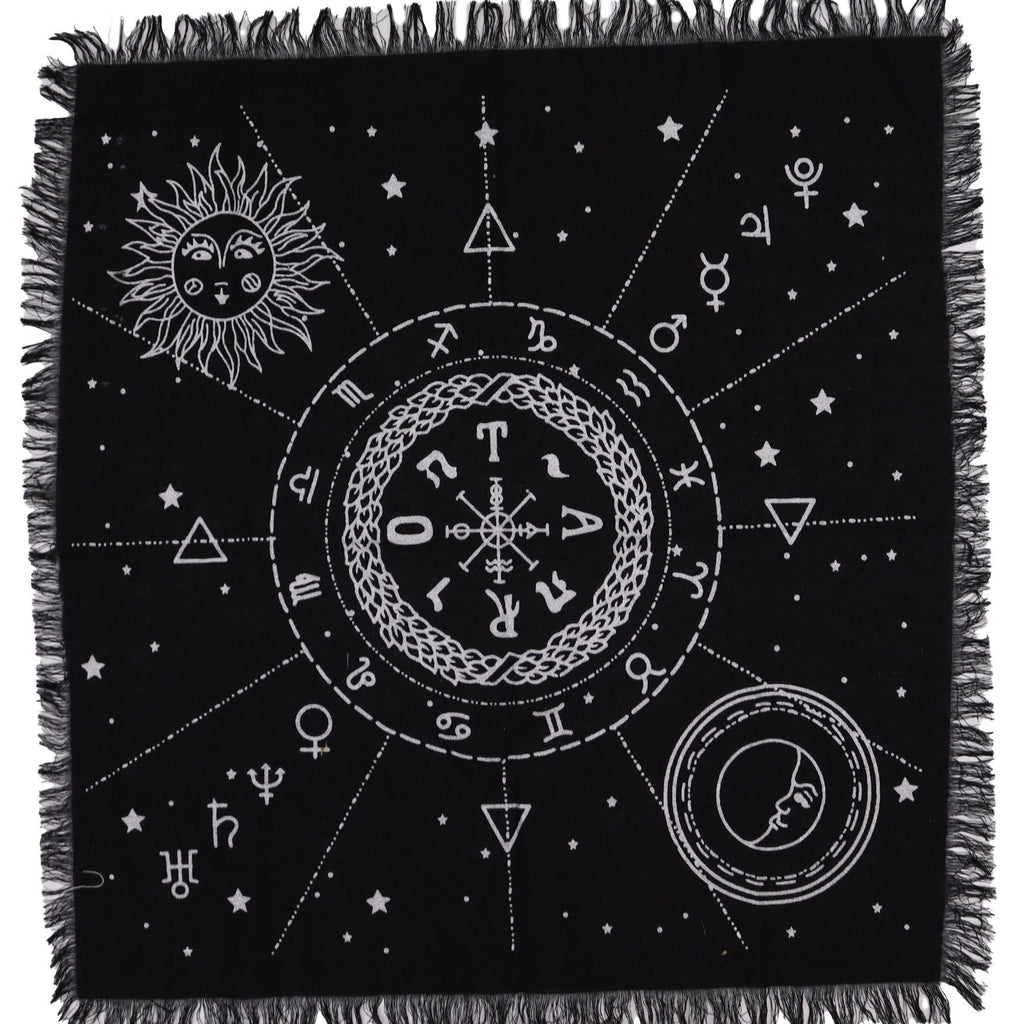 Black throw blanket with white symbols and fringes on a white background
