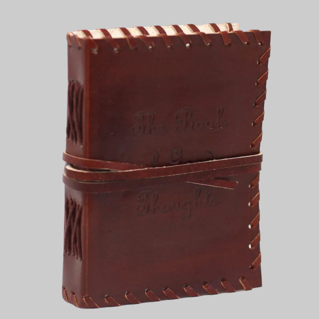 Brown leather notebook with stitching details on a white background