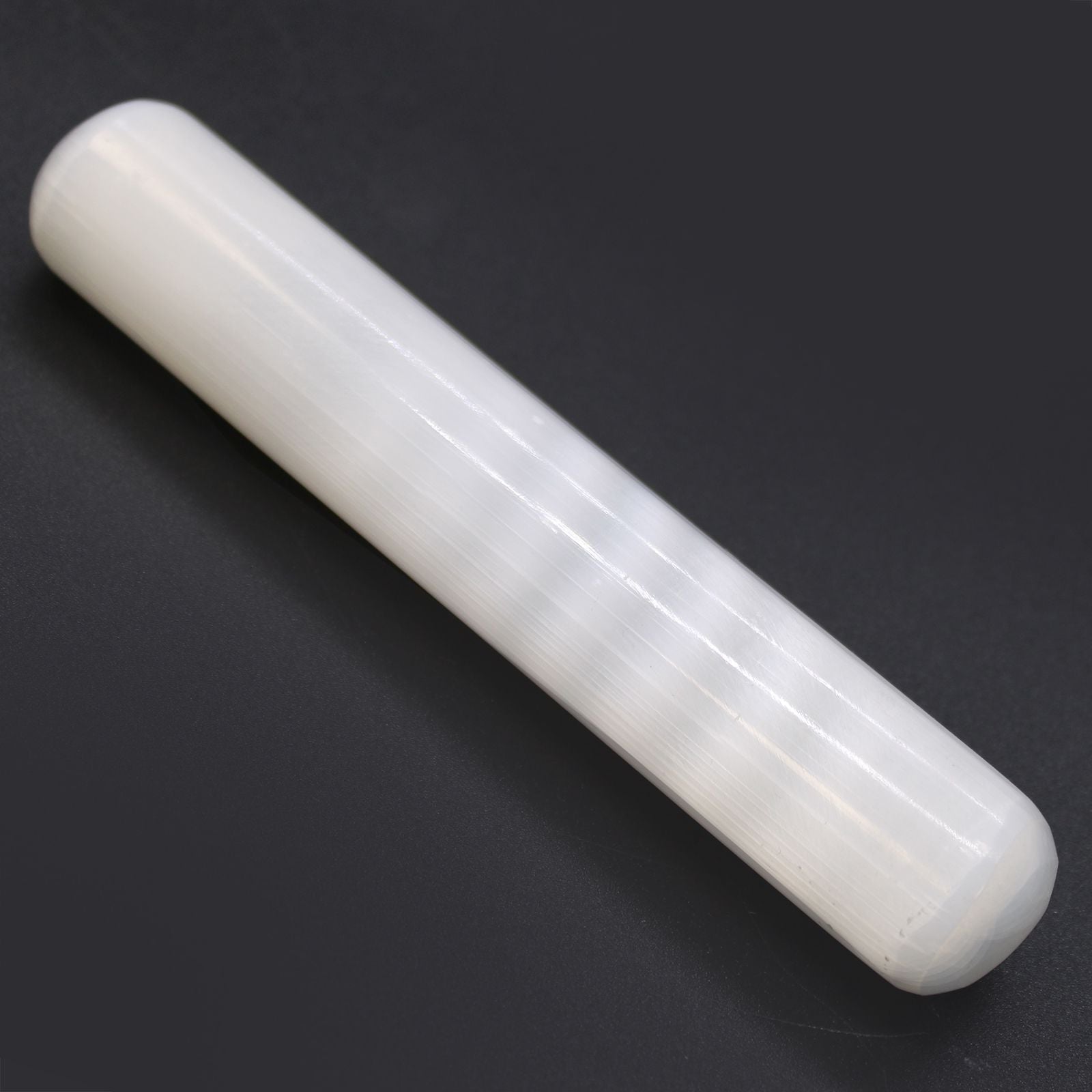 White cylindrical object on a black background