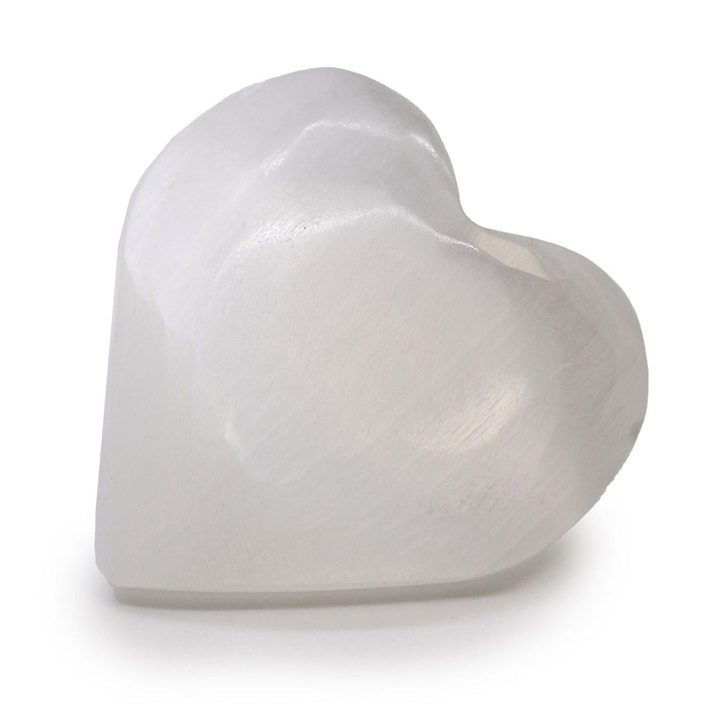 Heart-shaped white ceramic object on a white background