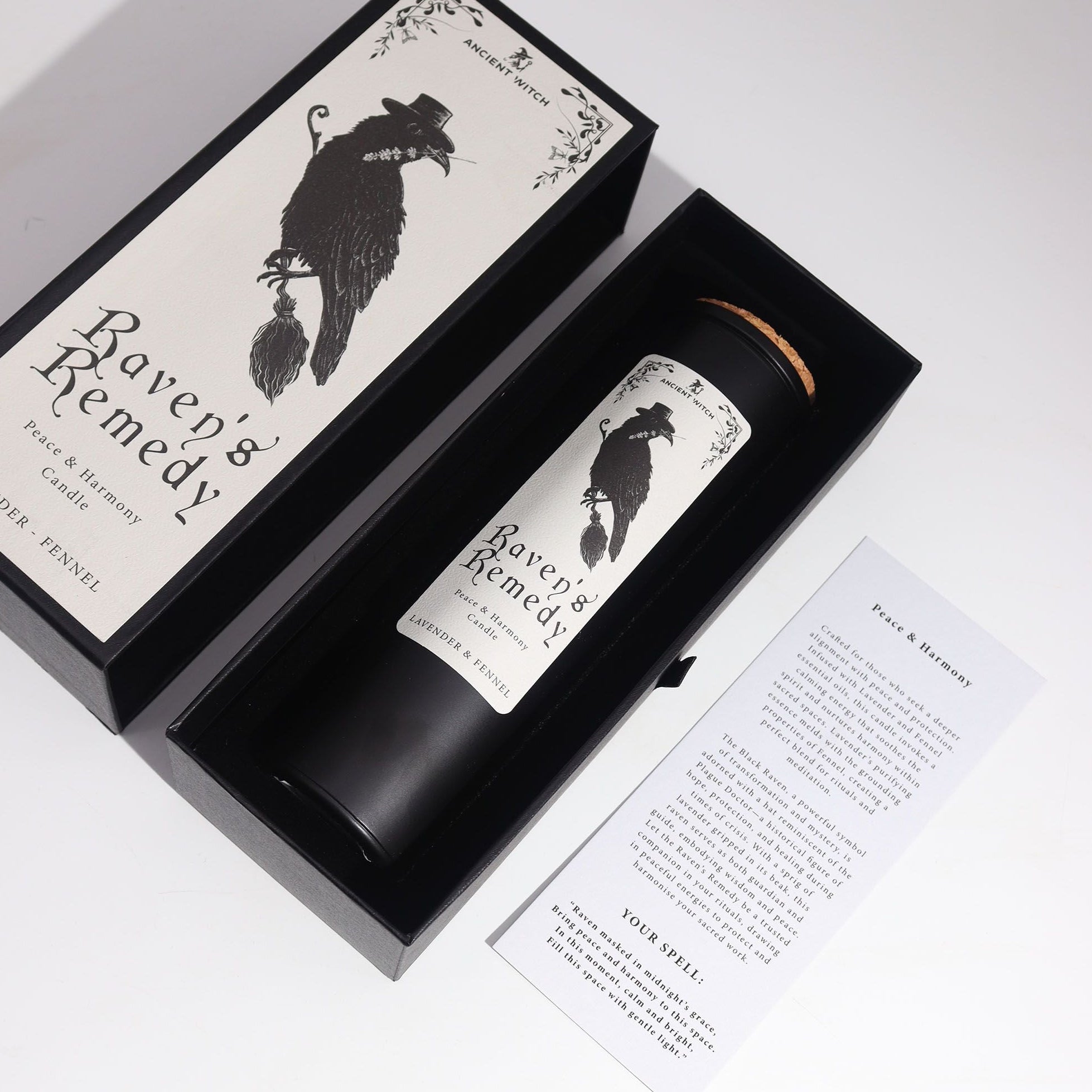 Candle labeled 'Raven's Remedy' in a decorative box with a black and white design.