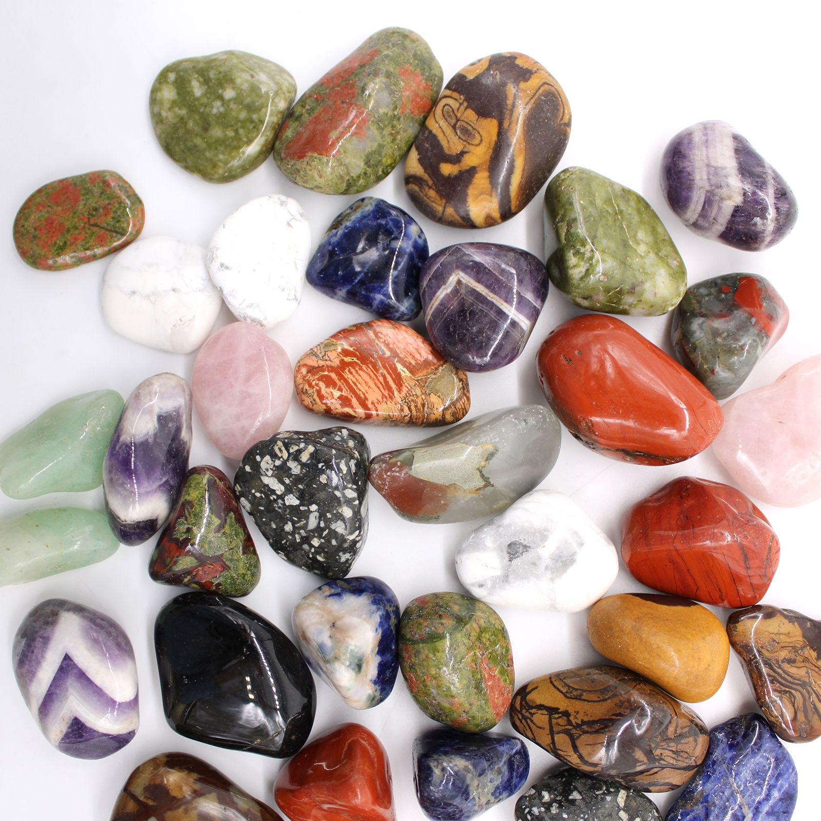 Assorted colorful stones on a white background