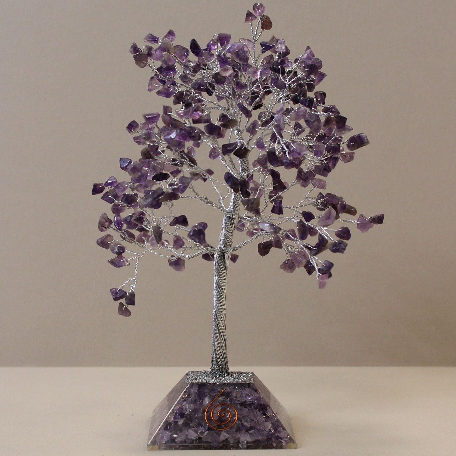 Amethyst crystal tree on a beige background