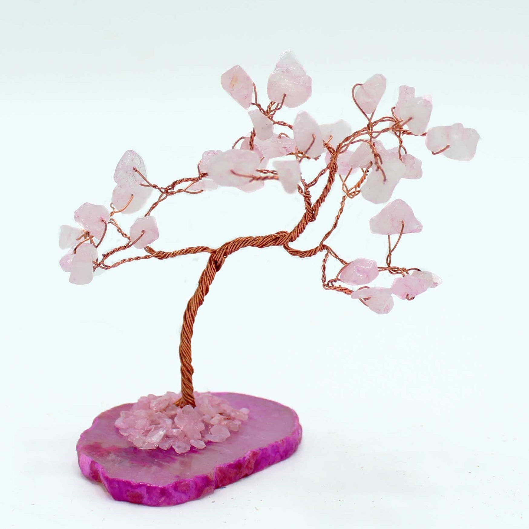 Decorative tree with pink branches on a pink base against a white background