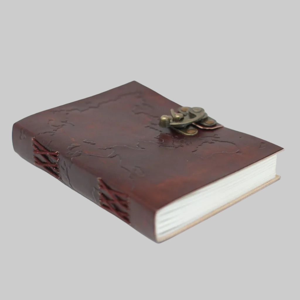 Brown leather notebook with embossed design and brass clasp on a white background