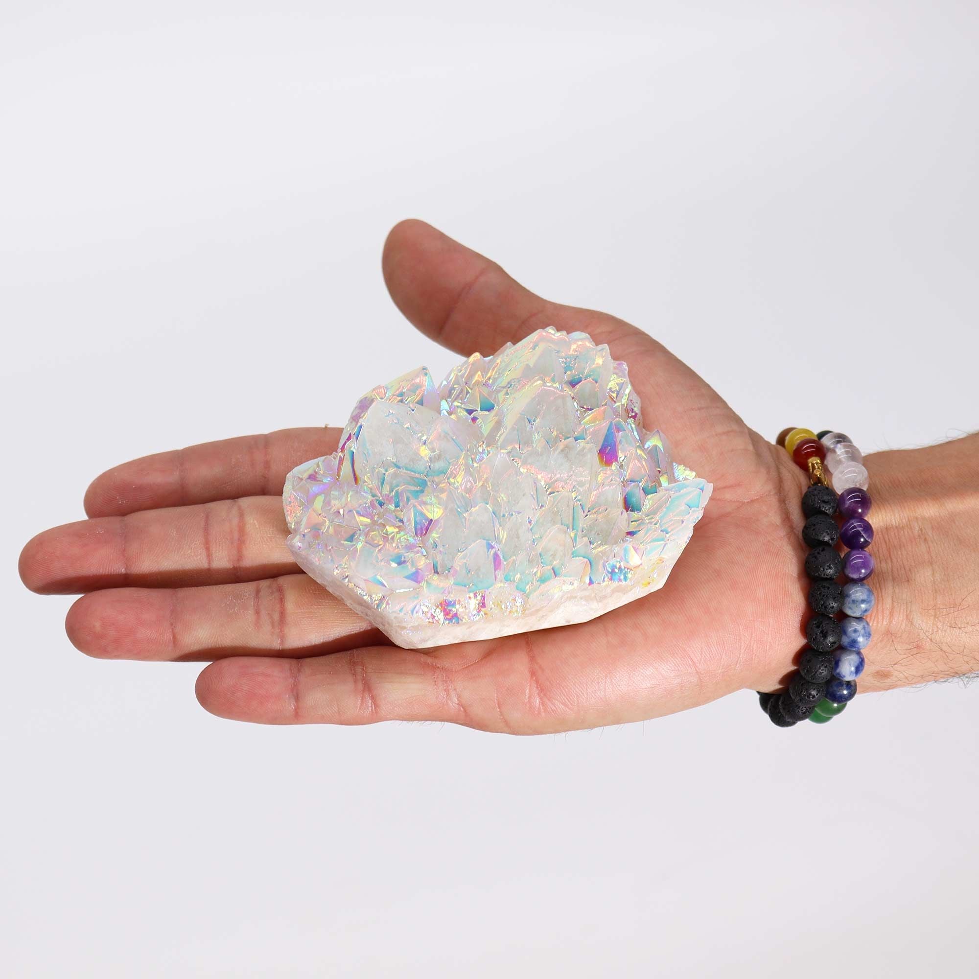 Hand holding a crystal geode with a plain background