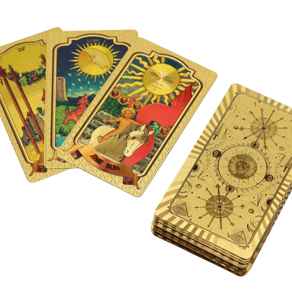 Gold tarot cards with intricate designs on a white background