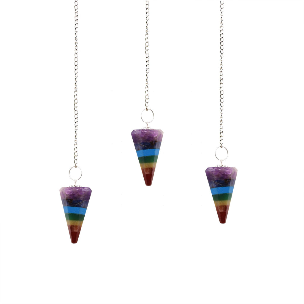 Three rainbow-colored pendulums on white background